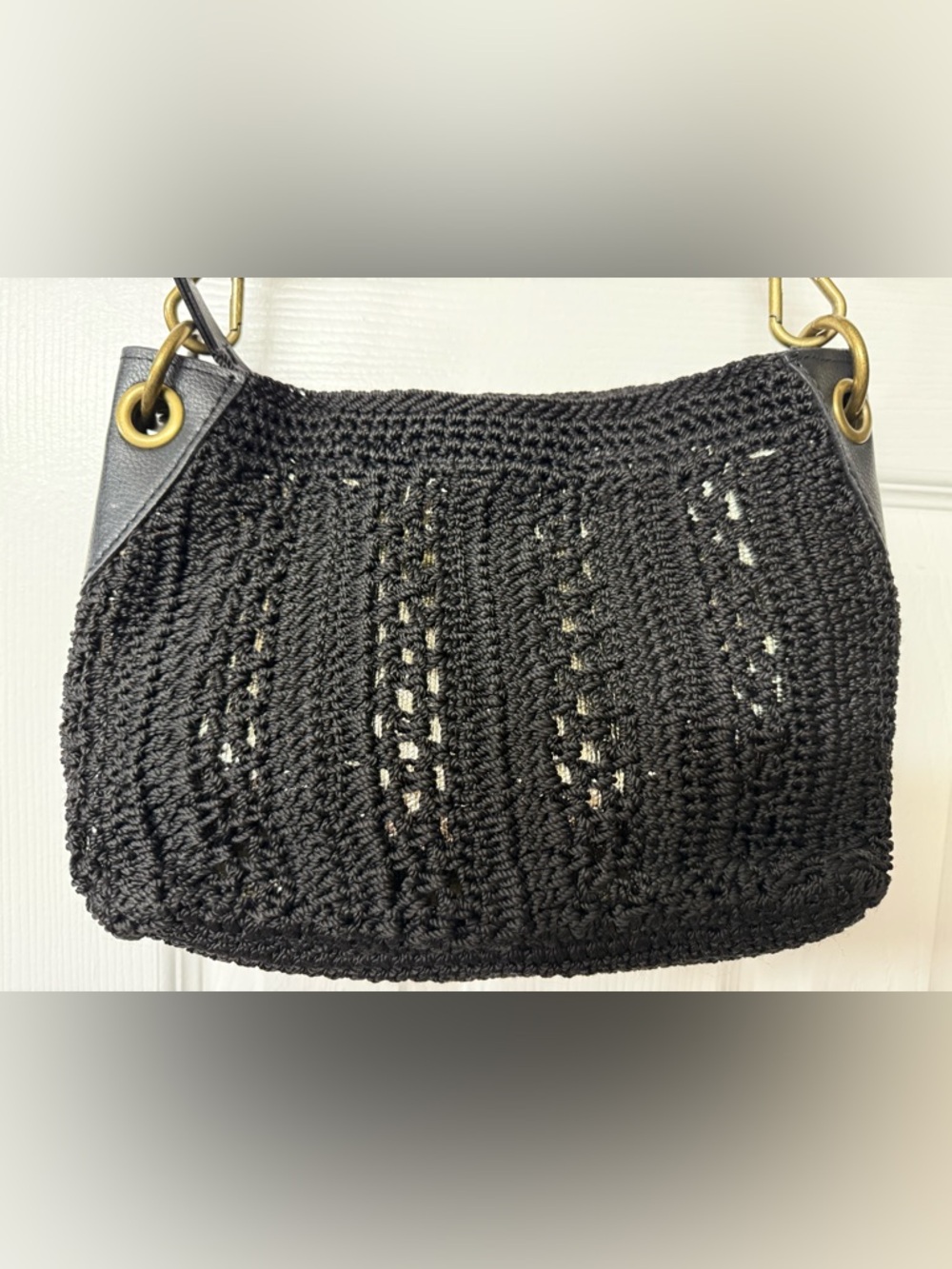 The Sak Black Crochet Shoulder Bag with Brass Ring Hardware